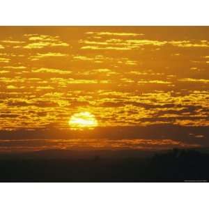 Cloud Filled Sky at Sunrise Over Outback Plains and a Cattle Station 