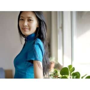 Young Chinese Woman Wearing a Traditional Chinese Blue Cheongsam 