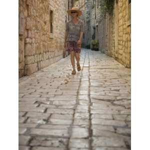  Woman walking in narrow cobblestone alley, Stari Grad Town 