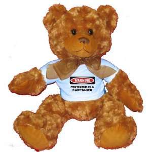   BY A CARETAKER Plush Teddy Bear with BLUE T Shirt: Toys & Games