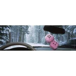  Fuzzy Dices Hanging from the Rear View Mirror of a Car 